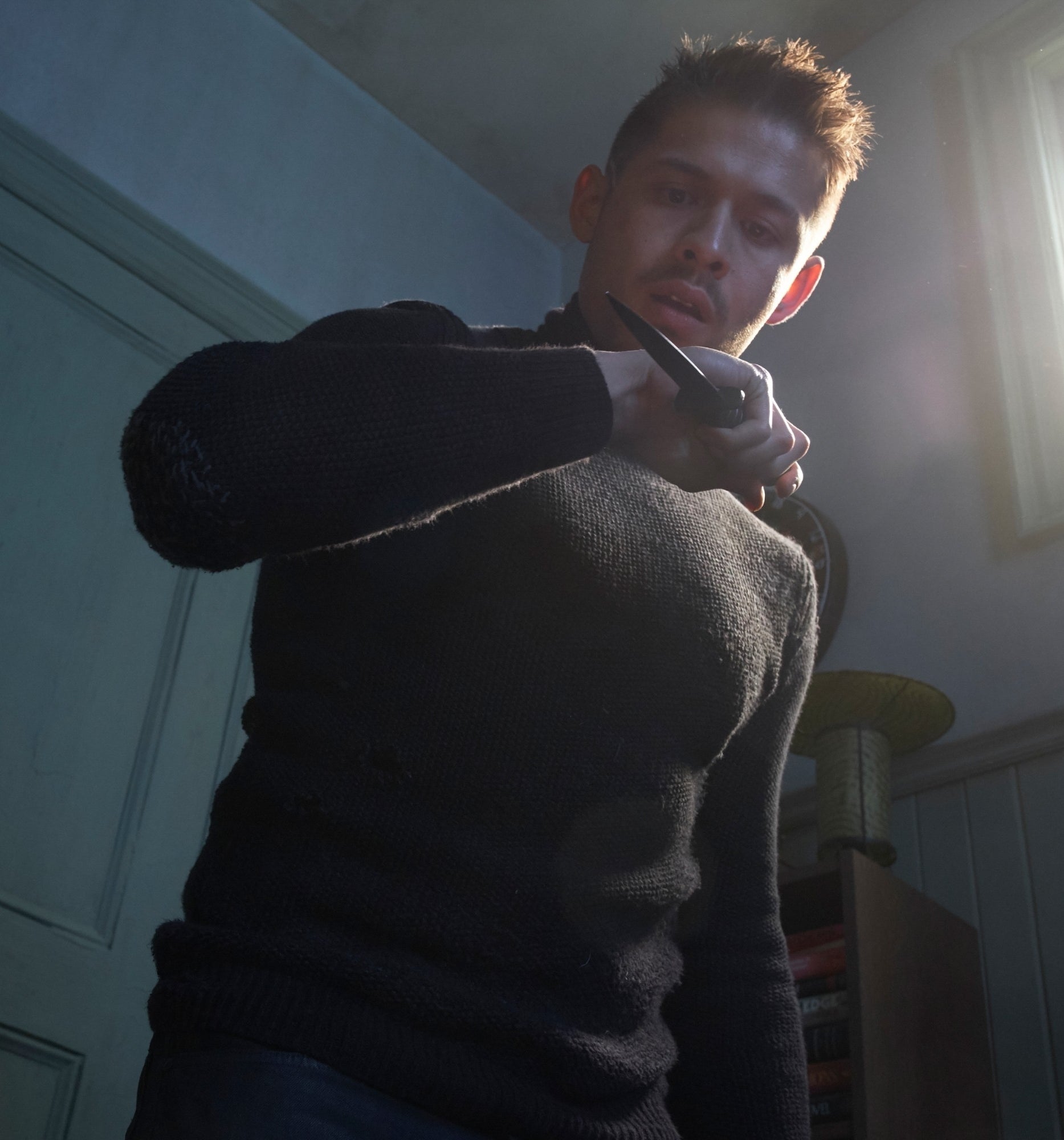 David Castañeda holding a weapon and wearing all black in "The Umbrella Academy"