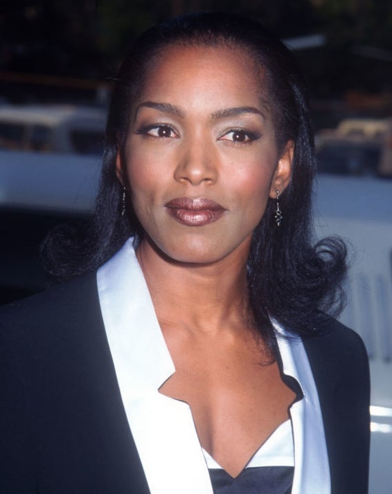 Angela Bassett in a stylish suit with a satin lapel and a v-neck top, standing outdoors