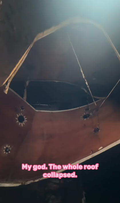 Damaged ceiling with a large collapsed section and text reading "My god. The whole roof collapsed."