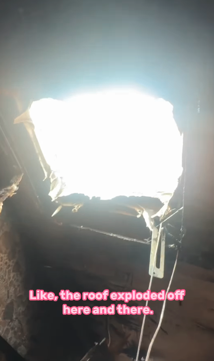 A damaged roof with a large hole exposing sunlight. Text at the bottom reads, "Like, the roof exploded off here and there."