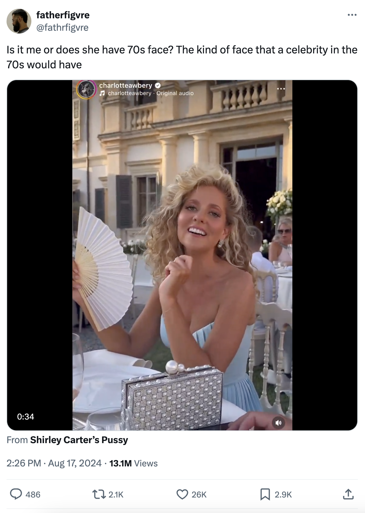 Charlotte Awbery, smiling in a light-colored off-the-shoulder dress, poses with a fan and sequined purse. Tweet asks if she has a '70s celebrity face