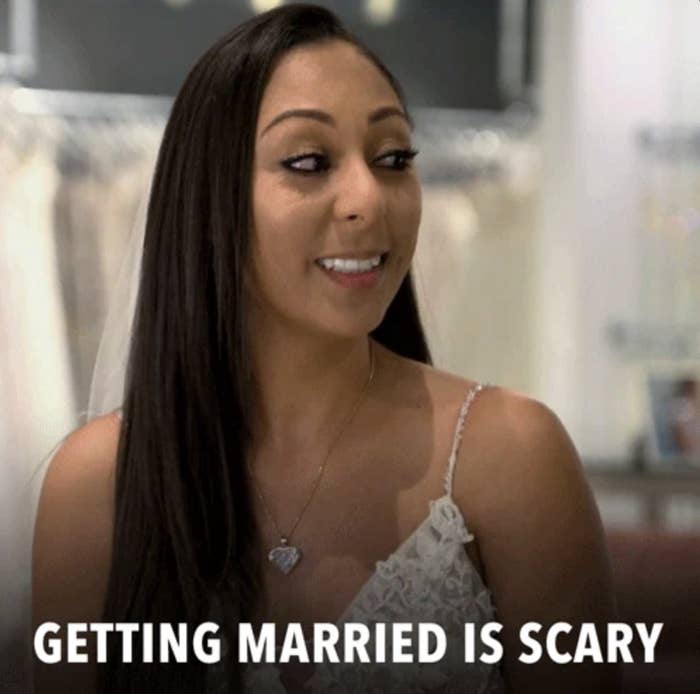 A woman in a bridal gown smiling with text overlay that reads, "Getting married is scary."