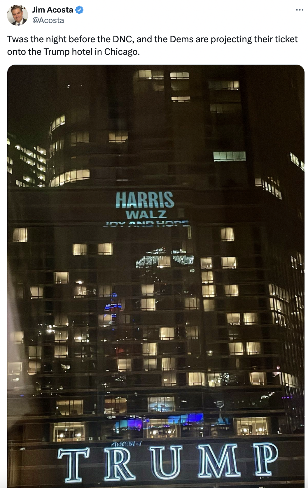 Jim Acosta tweet: "Twas the night before the DNC, and the Dems are projecting their ticket onto the Trump hotel in Chicago." The projection reads, "Harris, Walz, Biden."