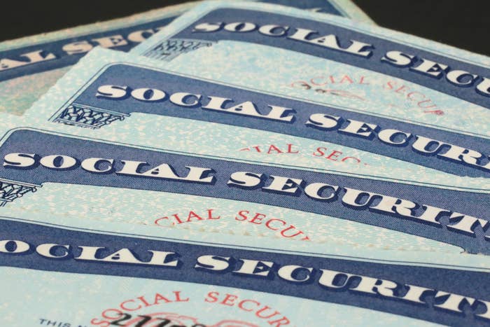 Several U.S. Social Security cards are overlapping to form a fan-like arrangement