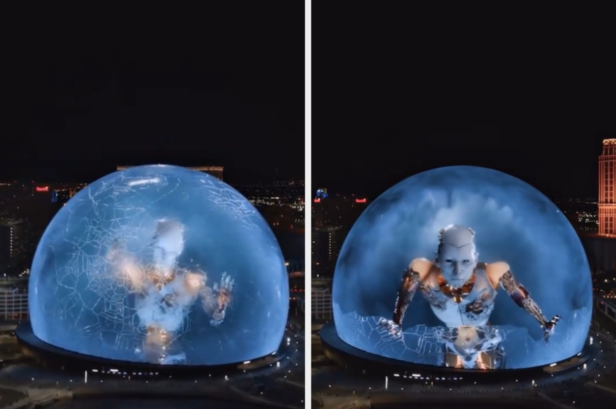 A large spherical screen shows digital animations of a humanoid figure appearing to break through and crawl inside it