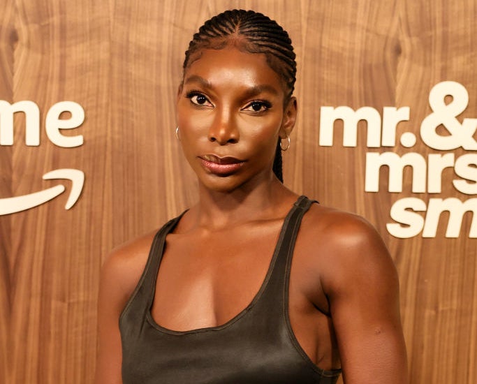 Michaela Coel poses in a sleeveless dress at the "Mr. & Mrs. Smith" event backdrop