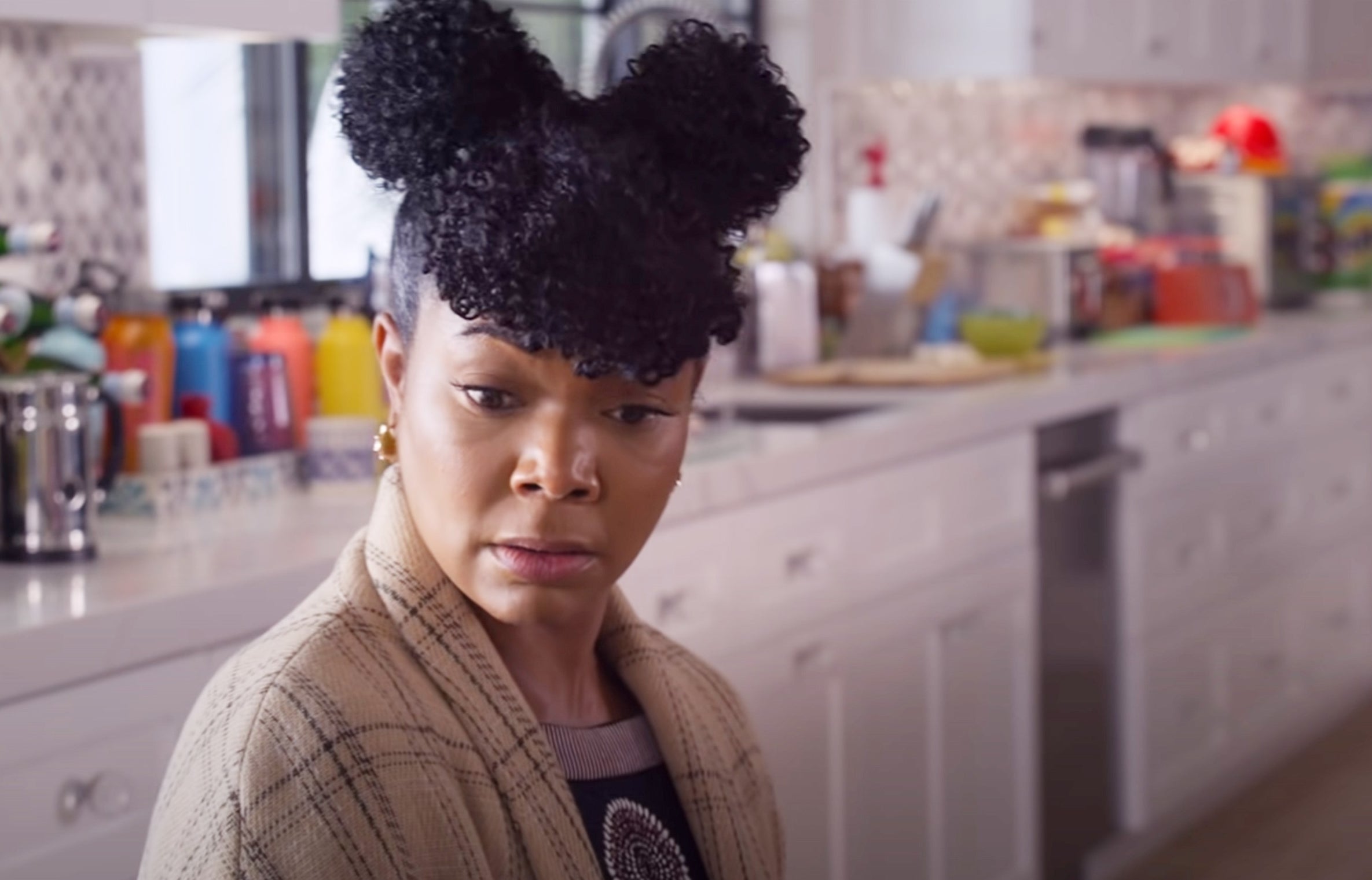 Gabrielle Union with space buns in her hair as she sits in the kitchen in &quot;Cheaper by the Dozen&quot;