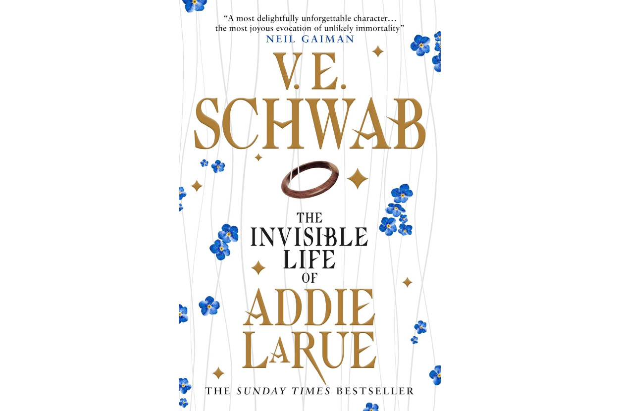 Book cover of &quot;The Invisible Life of Addie LaRue&quot; by V.E. Schwab. The cover features text and a ring, with blue flower illustrations. Quotes by Neil Gaiman and The Sunday Times Bestseller