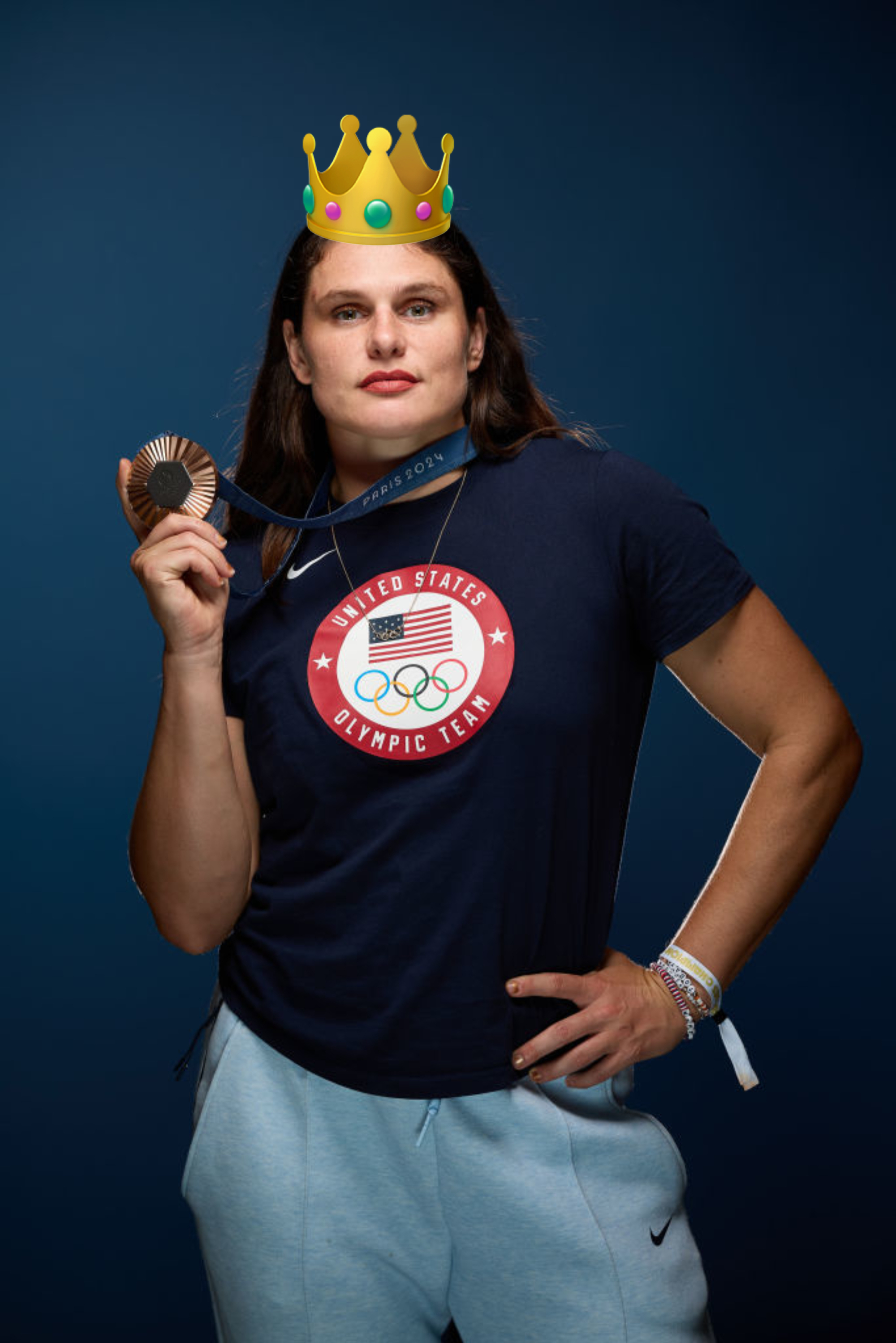 Olympic athlete Ilona Maher holding her bronze medal while wearing a United States Olympic Team t-shirt