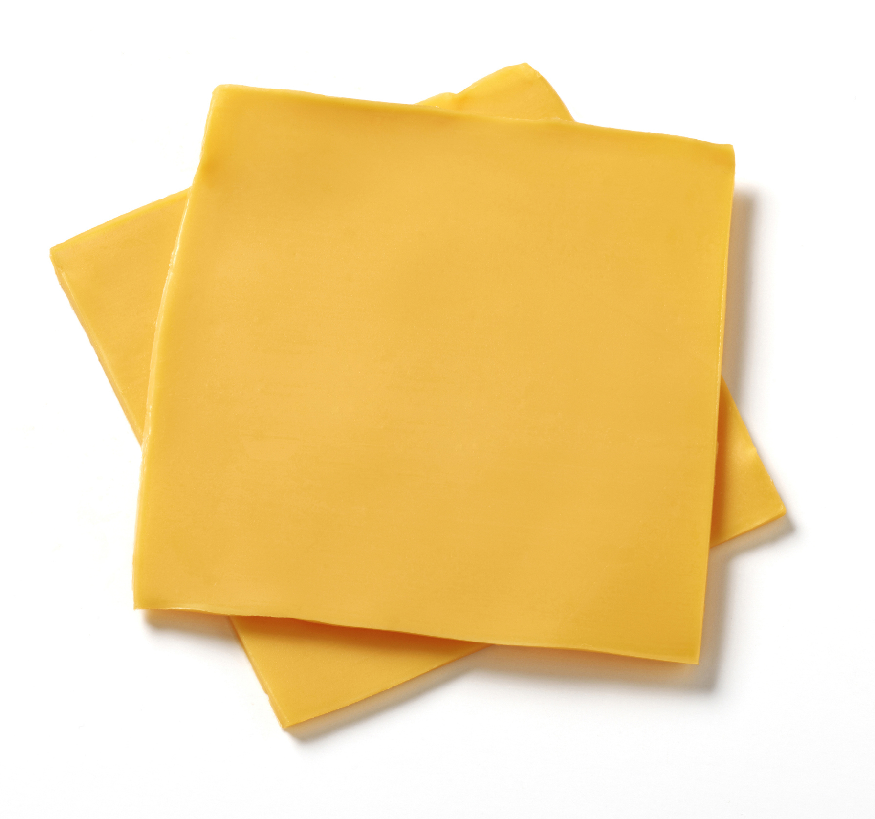 Two slices of processed cheese on a white background