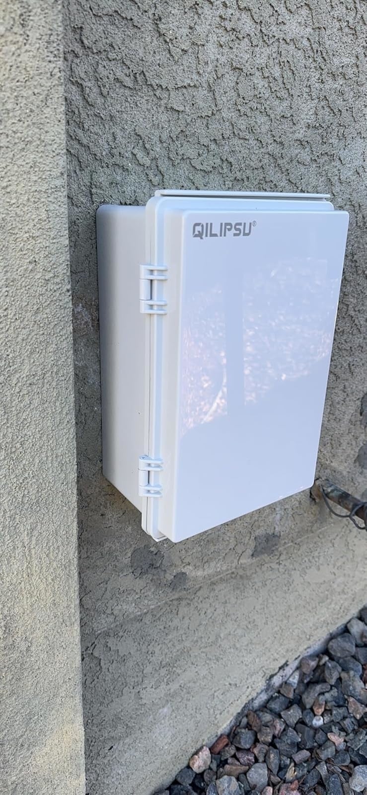 same achromatic  outdoor electrical container  mounted connected  a partition  with doorway  closed