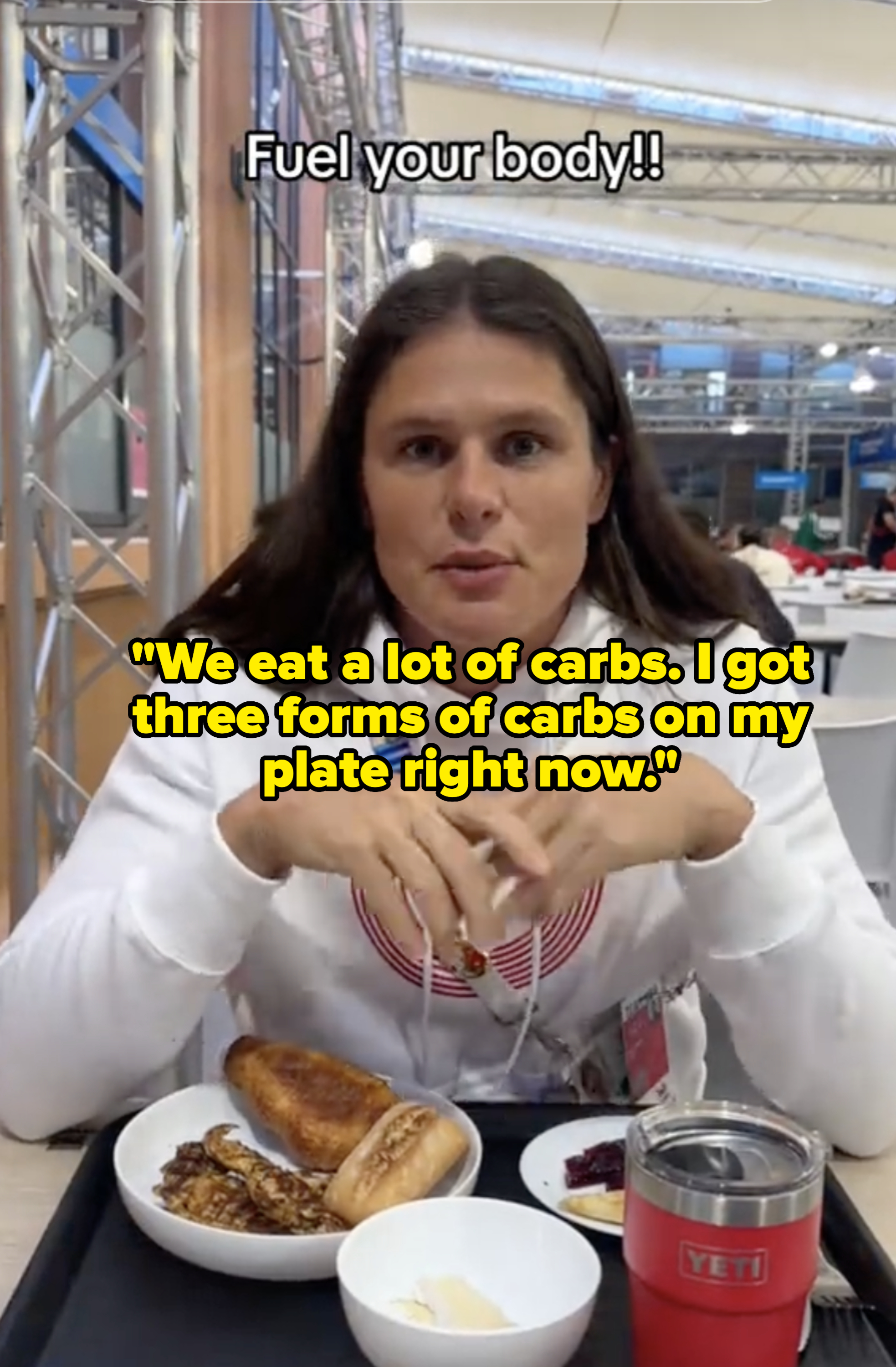 Person sits at a table with food, wearing a white hoodie. Text above reads &quot;Fuel your body!!&quot; Items on the table include toast, eggs, and a drink
