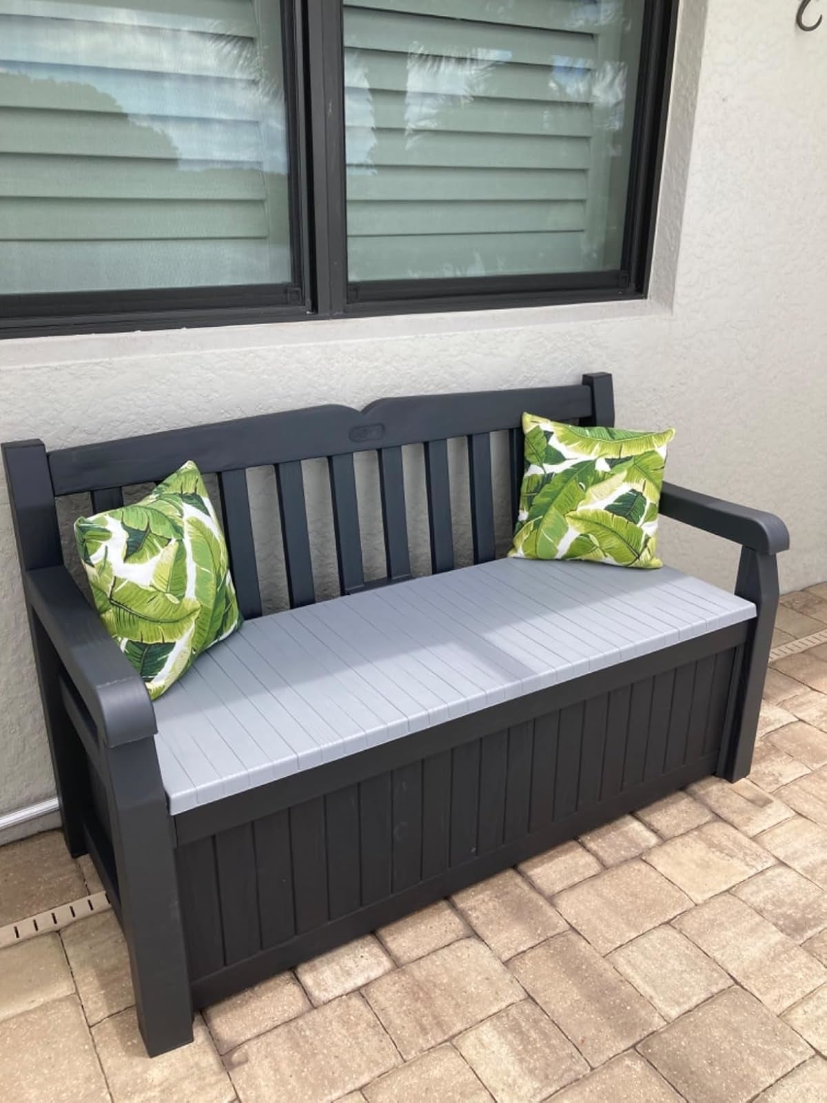 reviewer's outdoor retention  seat  with 2  greenish  propulsion  pillows connected  it