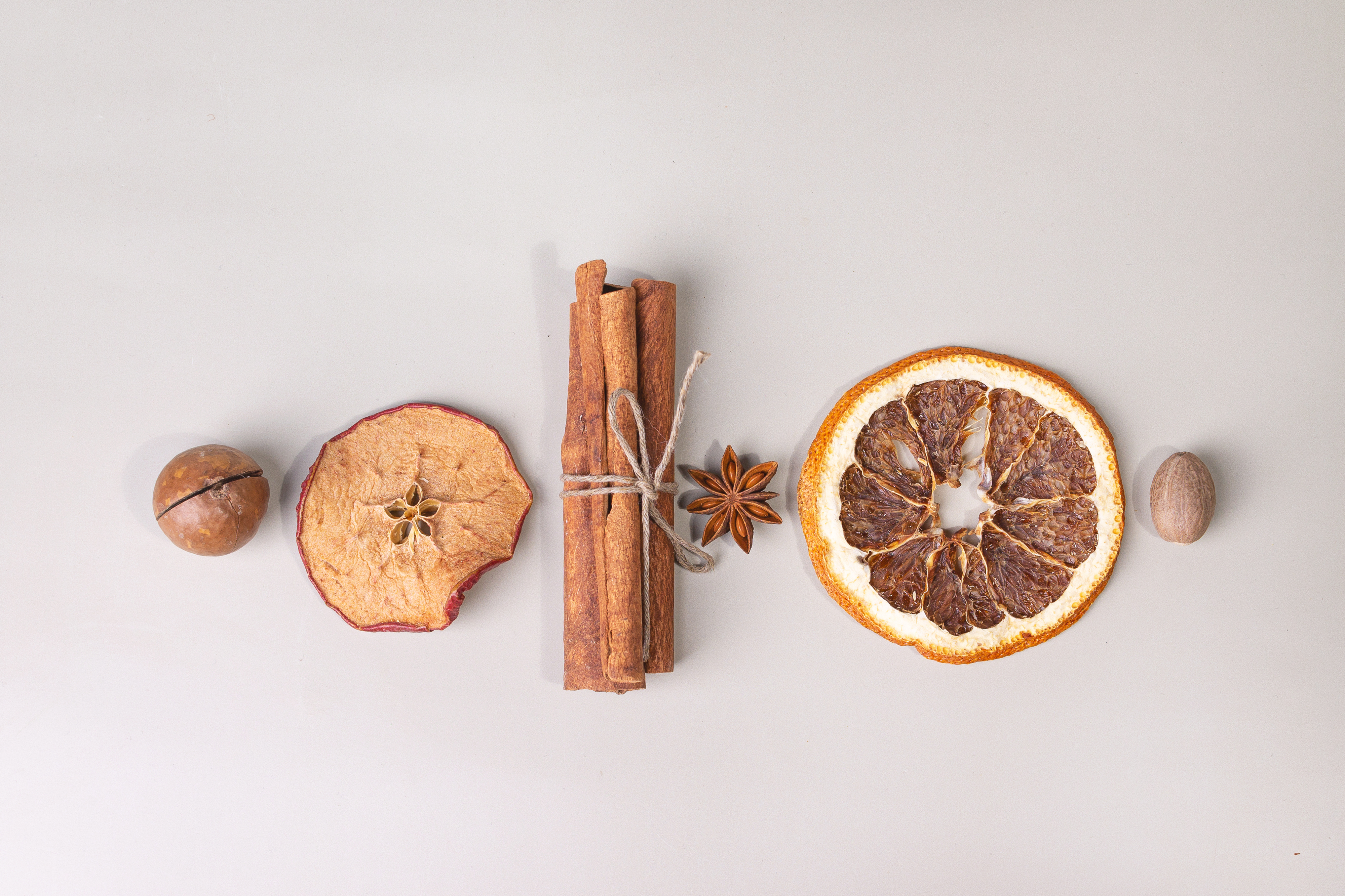 Dried apple slice, bundle of cinnamon sticks, star anise, dried orange slice, nutmeg