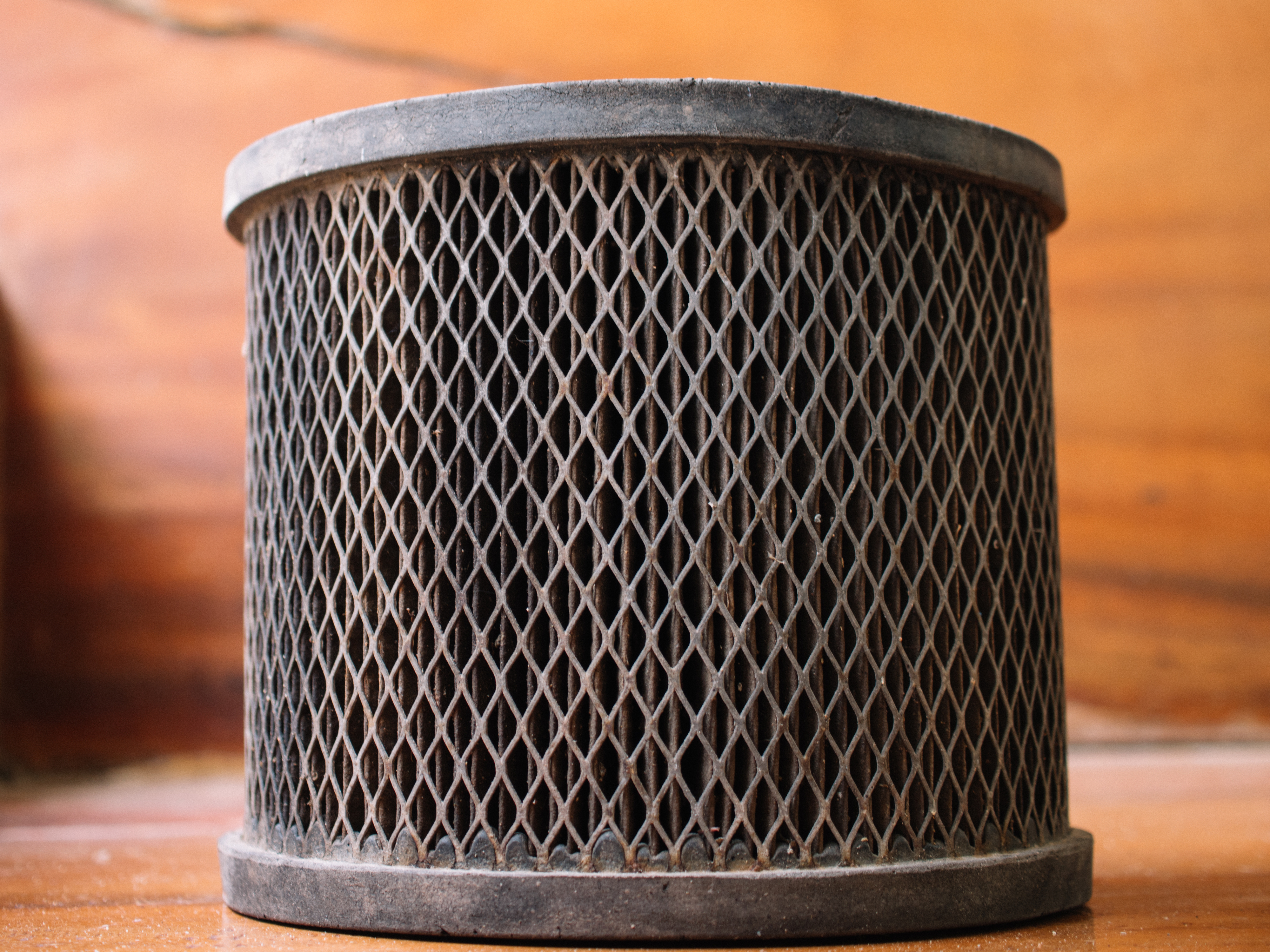 Close-up of a cylindrical air filter with a wire mesh exterior