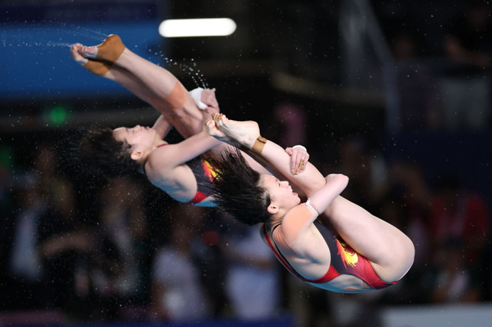 Chinese divers mid-air during synchronized dive at a competition