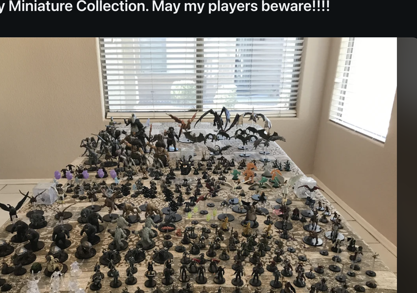 Image showing a Reddit post by r/nbd titled "OC, My Miniature Collection. May my players beware!!!!" featuring a table filled with numerous miniature figurines related to role-playing games