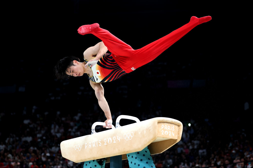 An athlete performs a difficult move on the pommel horse during the Paris 2024 Olympics
