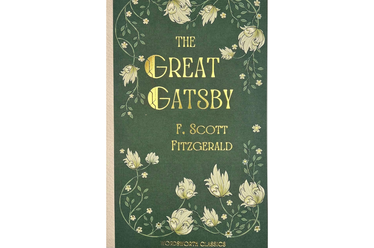 &quot;The Great Gatsby&quot; by F. Scott Fitzgerald, cover art features floral designs and gold lettering