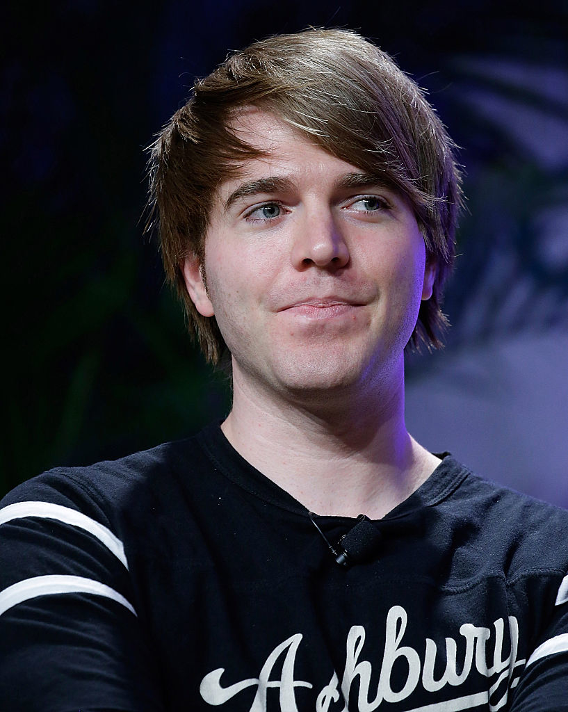 Shane Dawson is shown in this image. He is wearing a casual shirt with a partial view of the word "Ashbury" visible on it