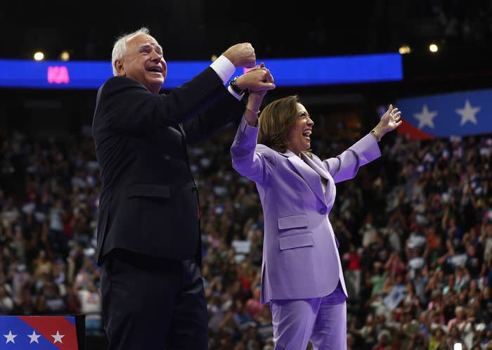 Kamala Harris and Tim Walz raising their hands at a Democratic rally