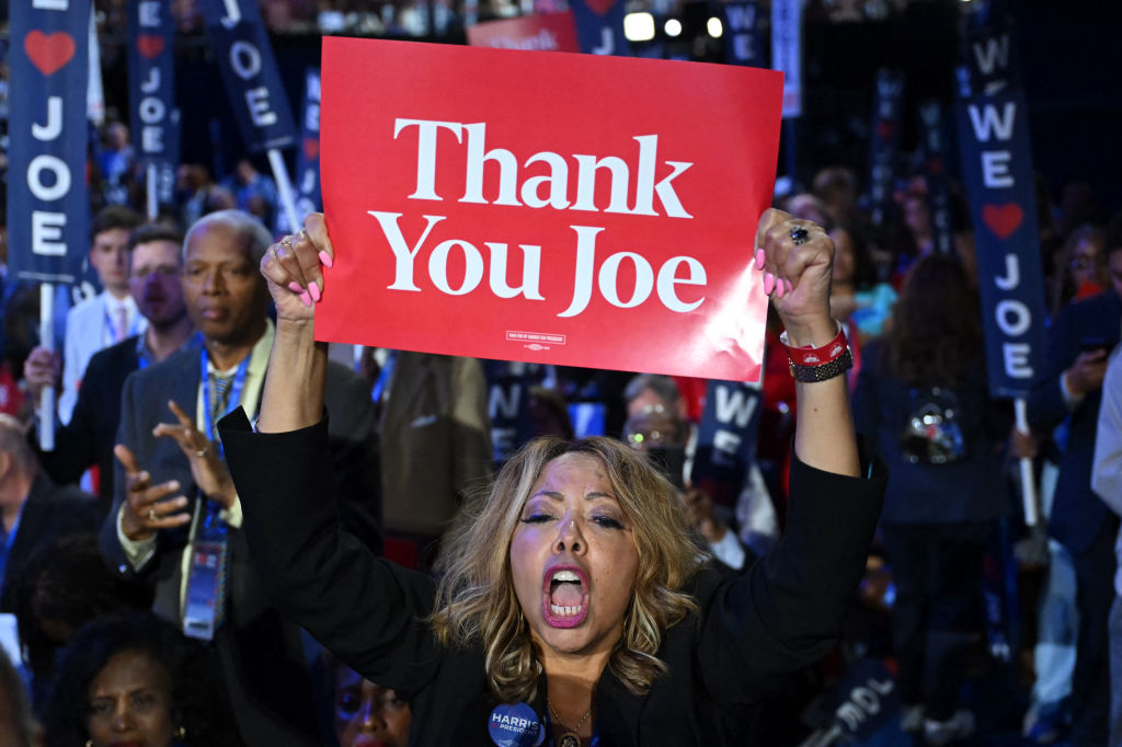 Lucy McBath holds a &quot;Thank You Joe&quot; sign at a political rally, surrounded by people with &quot;We ♡ Joe&quot; signs