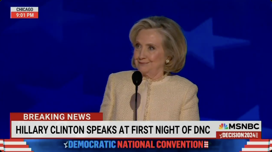 Hillary Clinton speaks at the first night of the Democratic National Convention, aired on MSNBC, with a label indicating &quot;Breaking News&quot;