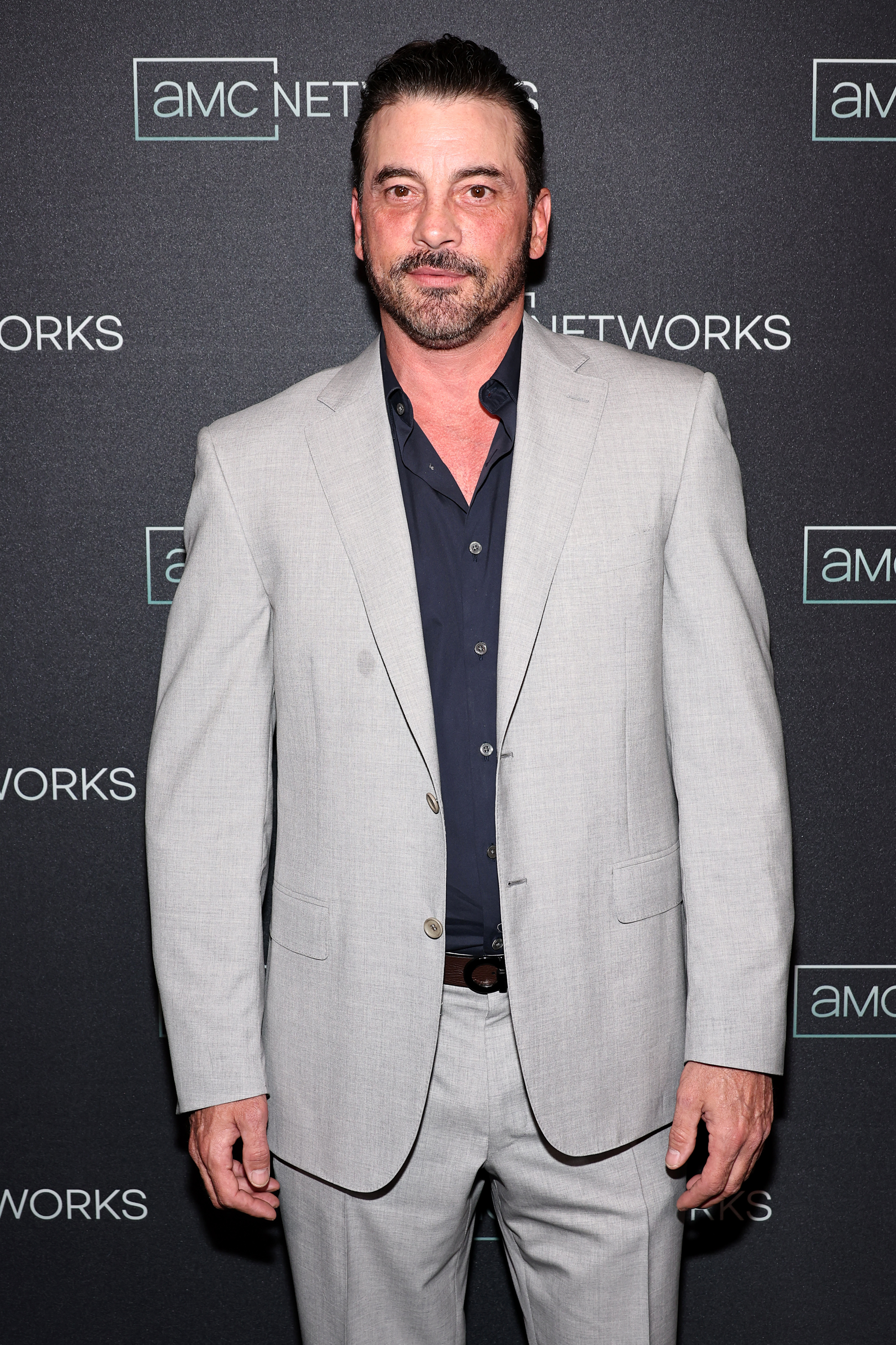 Skeet Ulrich at an AMC Networks event wearing a light gray suit with a dark shirt