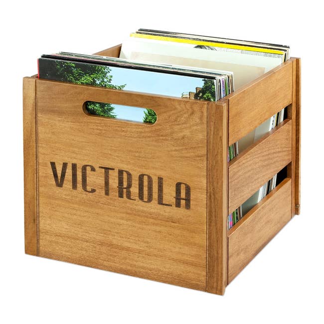 Wooden storage crate by Victrola holding vinyl records