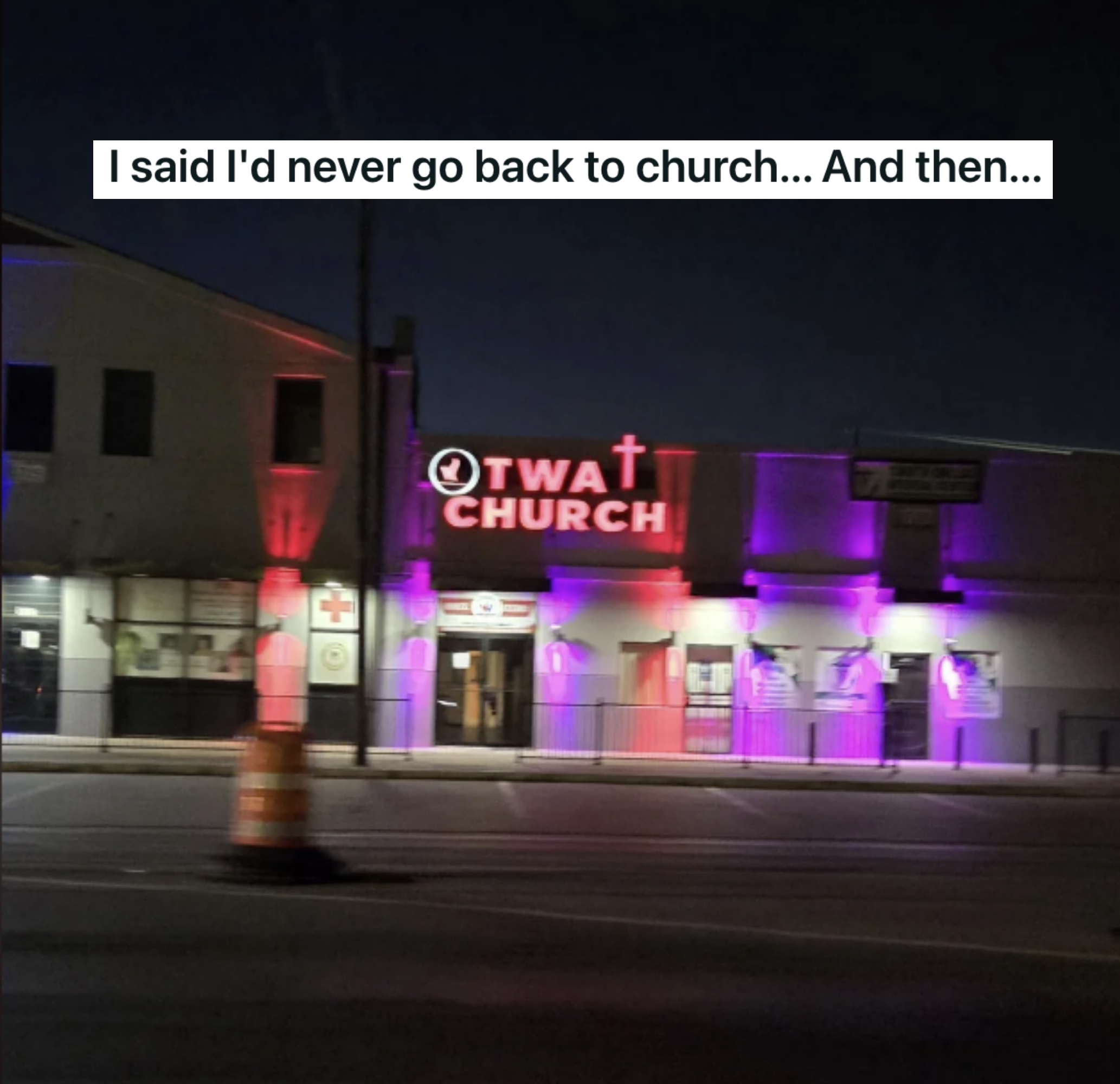 Street view at night of the "Owat C-H-U-R-C-H" building with illuminated pillars and windows in different colors