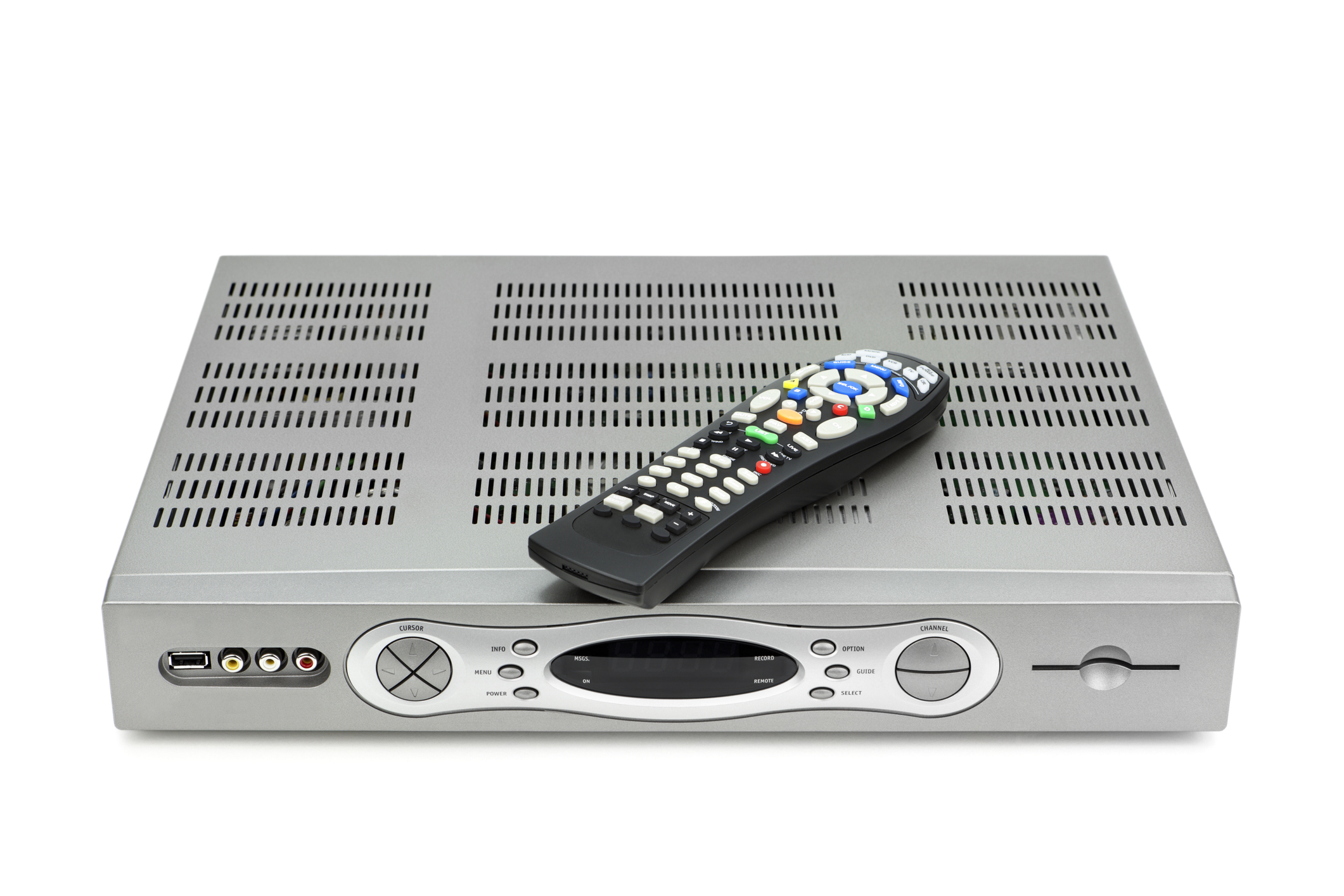A set-top box with ventilation slits on top, featuring a variety of input/output ports, and a remote control placed on it