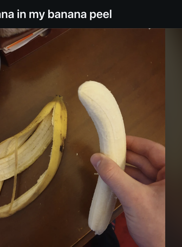 A hand holding a peeled banana next to an intact banana peel, highlighting the curiosity of finding a peeled banana still inside its peel, as seen on a Reddit post