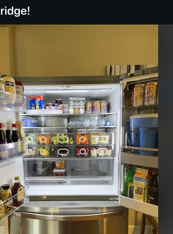 Open refrigerator showing organized shelves with various food items and containers inside. Reddit post title: &quot;Tried to organize my fridge!&quot; from r/OrganizationPorn
