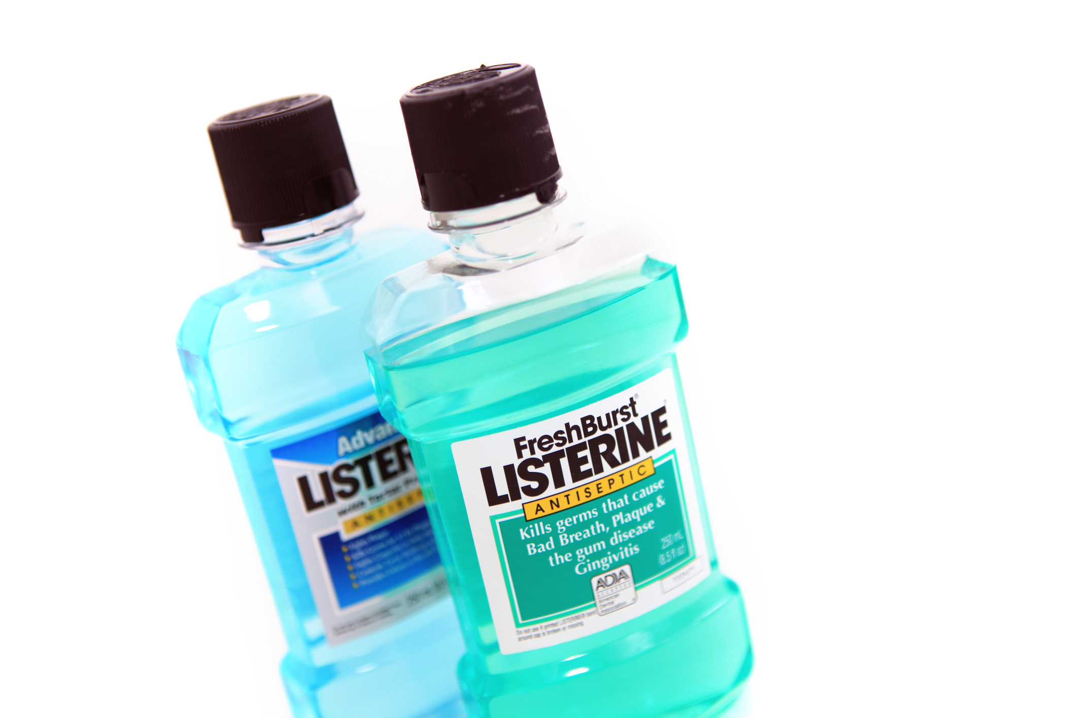 Two bottles of Listerine mouthwash, one labeled "FreshBurst" and the other "Advanced."