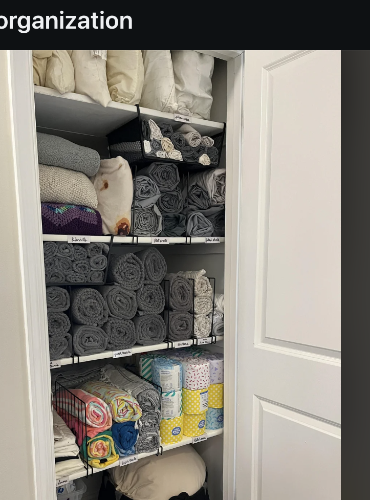 &quot;Image shows a neatly organized linen closet with towels, tissue boxes, and blankets. Shelves are orderly with items stacked and rolled efficiently.&quot;