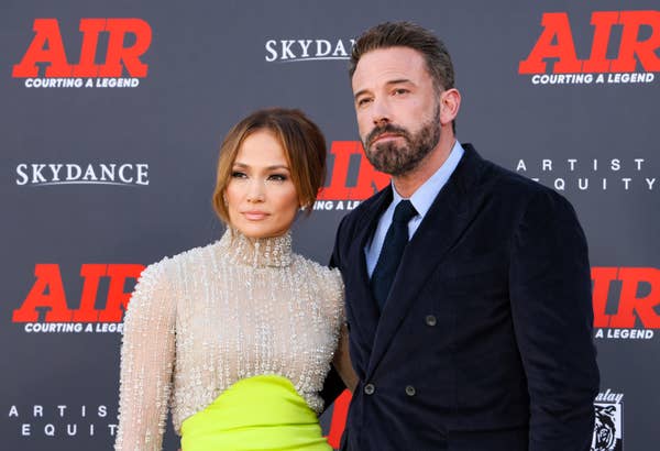 Jennifer Lopez in a sparkling gown with a lime-green skirt and Ben Affleck in a dark suit at the premiere of &quot;Air: Courting a Legend&quot; posing on the red carpet