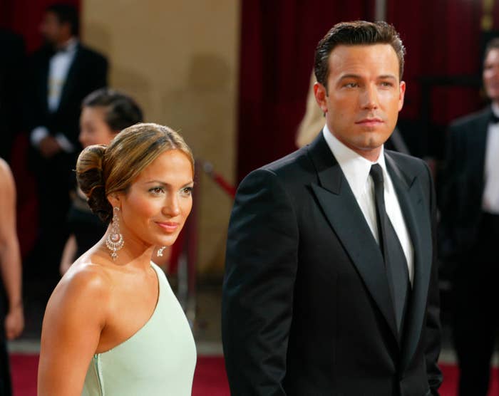 Jennifer Lopez in an elegant gown and Ben Affleck in a formal tuxedo walking the red carpet at an event