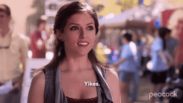 Anna Kendrick standing outdoors, looking surprised, with "Yikes." written in text overlay