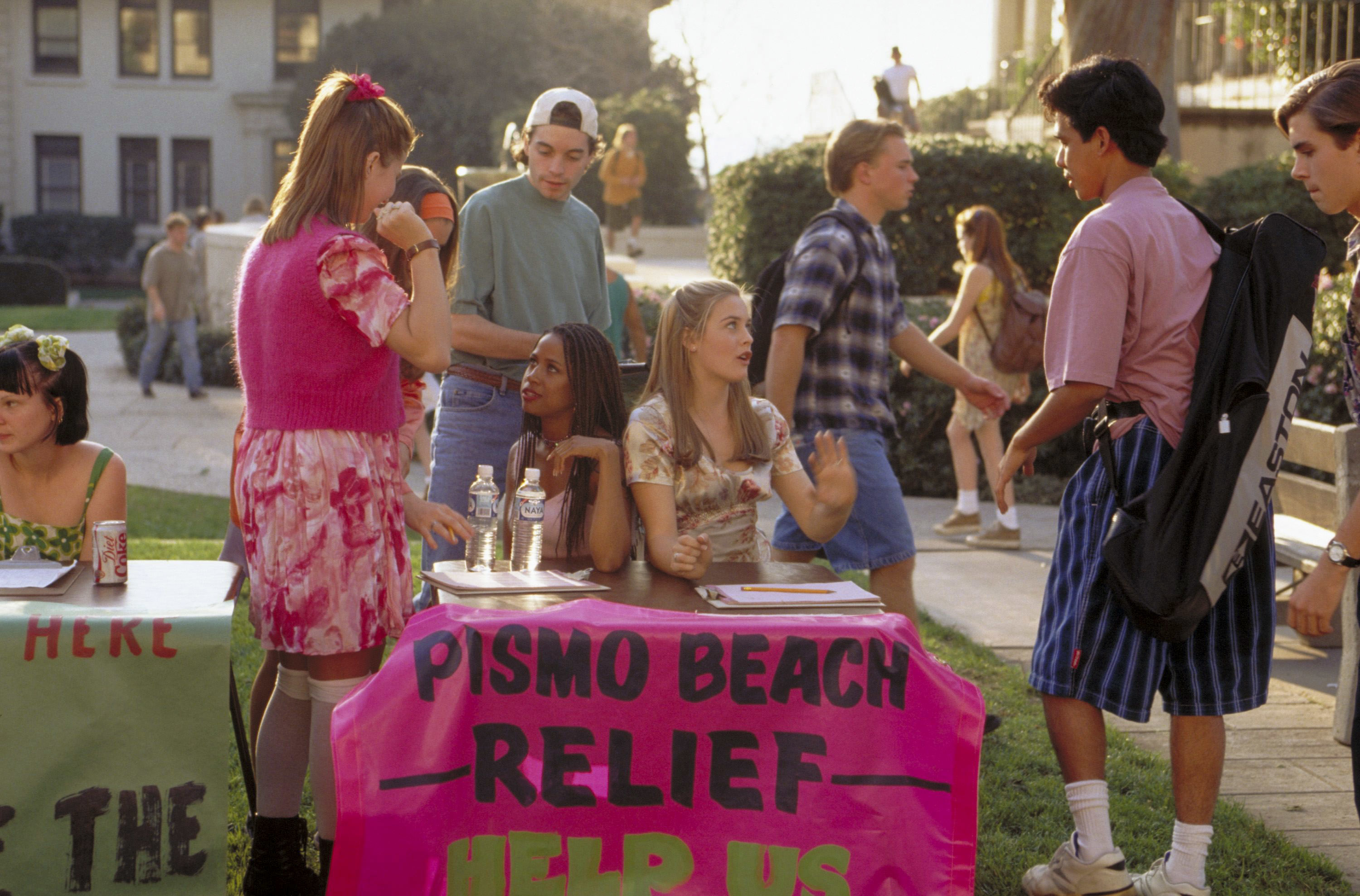A group of high school students, including Alicia Silverstone, Stacey Dash, and Brittany Murphy, participate in a "Pismo Beach Relief" fundraiser event on campus