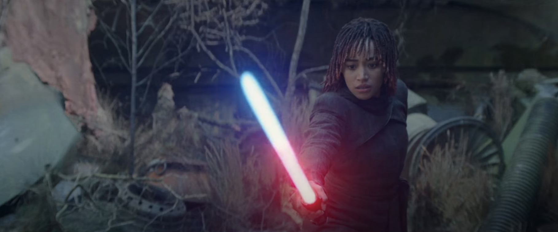 Amandla Stenberg holds a lightsaber