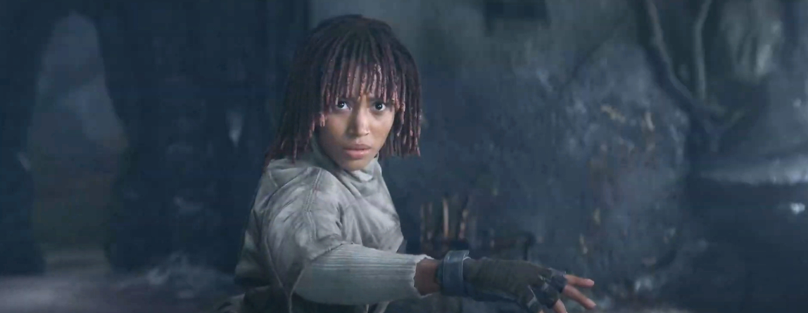 One of the characters gazes intensely forward with an arm extended, ready for action