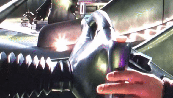 A person in protective gloves is handling a large, shiny, futuristic device or tool, which has a mechanical and industrial appearance