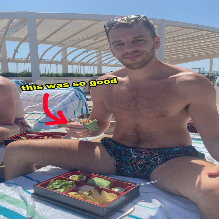 Man in swim trunks sitting on beach chair holds a small cup of food, with text "this was so good" and a red arrow pointing to the cup