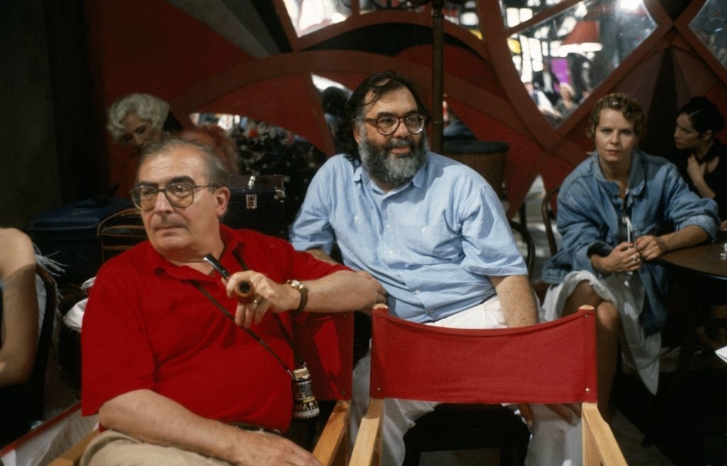 Paul Bartel, Francis Ford Coppola, and Laurie Metcalf seated in what appears to be a casual setting. Paul wears a red shirt and holds a pipe; Francis wears a light shirt
