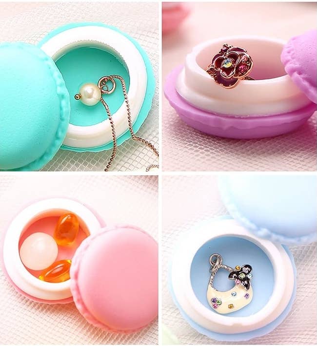 Small macaron-shaped jewelry boxes holding rings, necklaces, and earrings