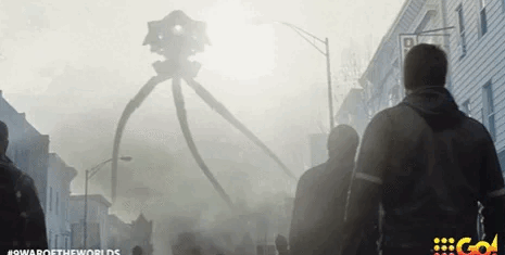Giant tripod machine emits light in a smoky street as people watch.