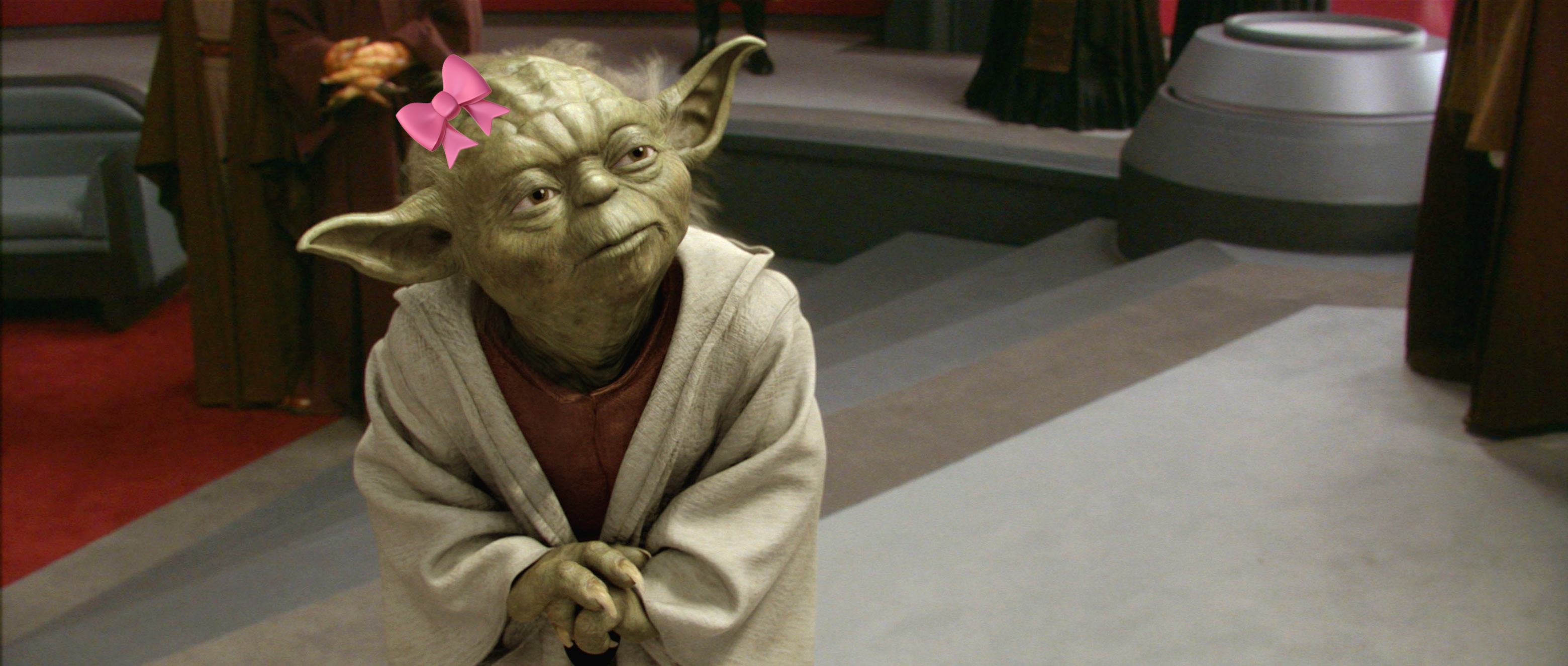 Yoda, a character from Star Wars, stands thoughtfully in a room with other individuals in the background
