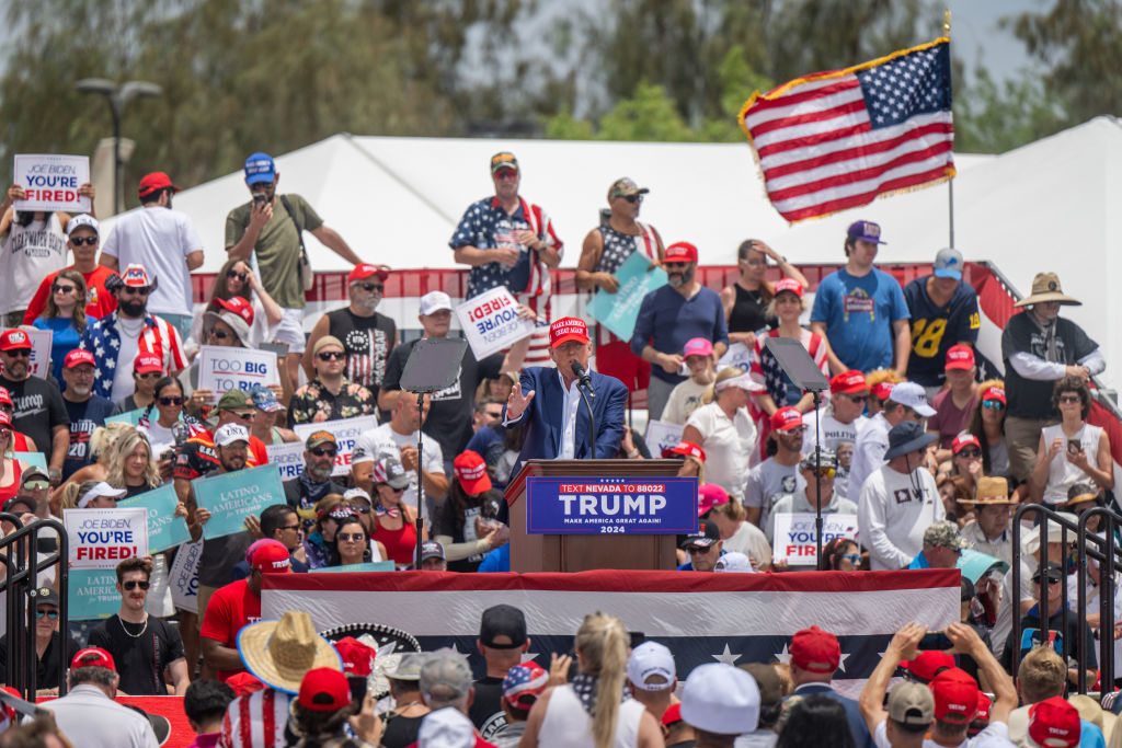Donald Trump speaks at a podium outdoors