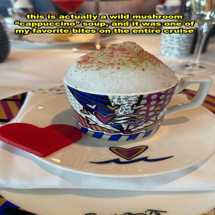 A cappuccino cup filled with soup and foamy broth