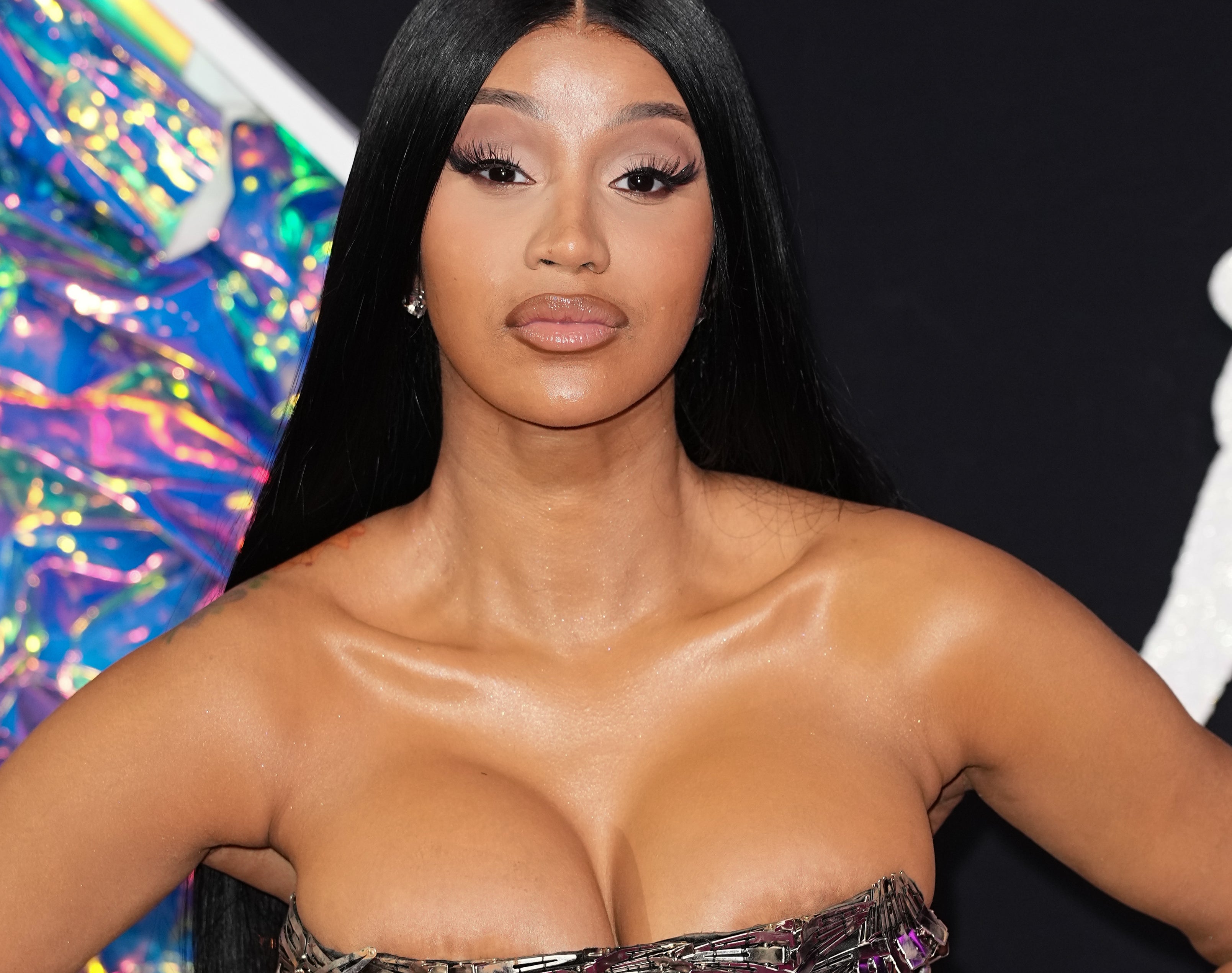 Cardi B wearing a strapless, metallic patterned gown on the red carpet